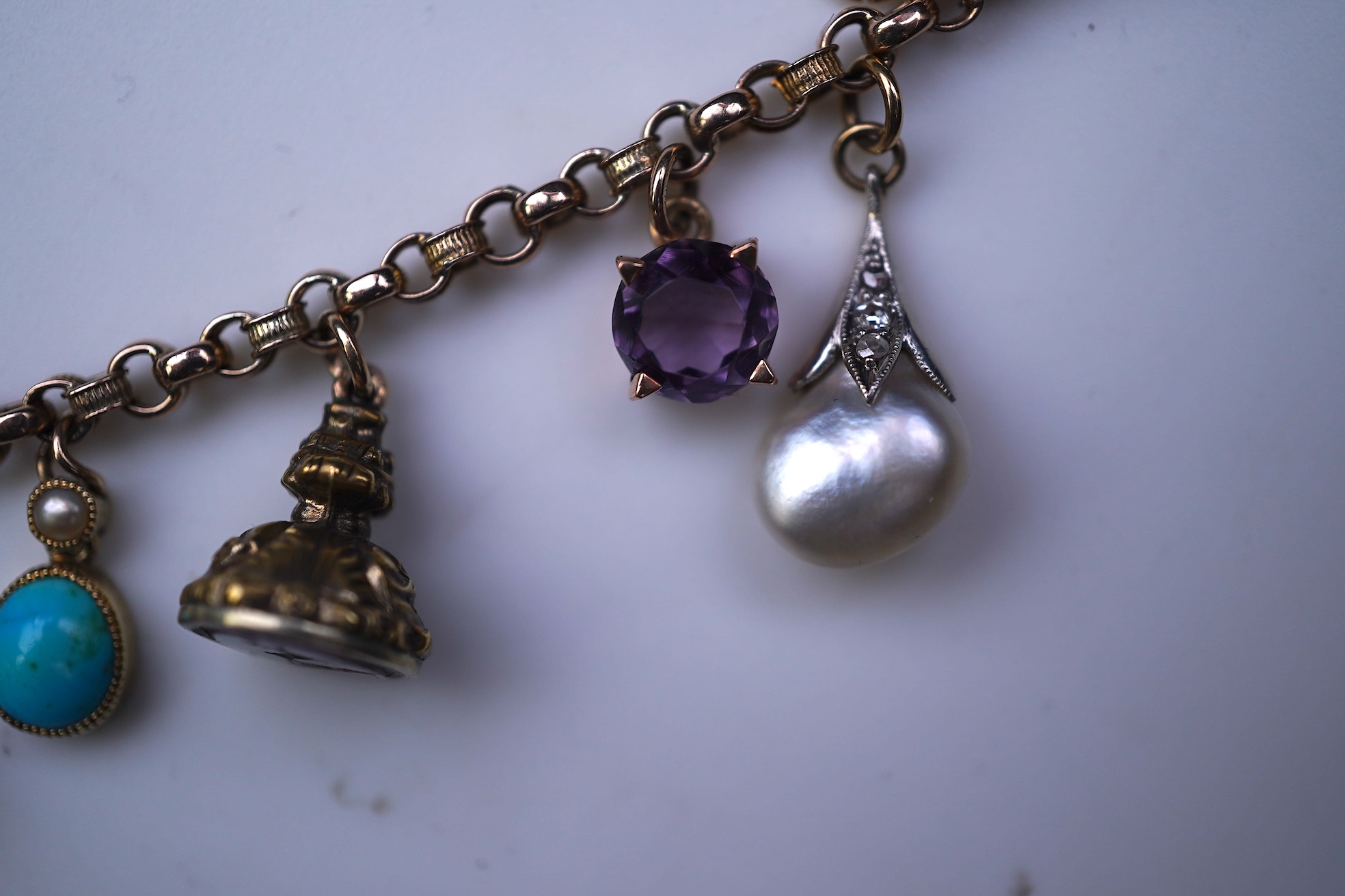 A gem-set charm bracelet, late 19th-early 20th century